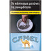 A Camel cigarette pack design with Greek warning text at the top, a photo of a hand lighting tobacco in an ashtray, and a blue lower section with the Camel logo and camel illustration.